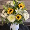 Bouquet of sunflowers, white lilies, and white chrysanthemums in a white vase