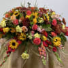 Large mixed floral arrangement with sunflowers, roses, and carnations