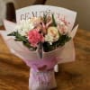 Pink and white bouquet with roses and carnations wrapped in pastel paper