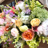 Soft, garden-fresh for the season make this arrangement feel like a warm