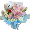 A charming bouquet featuring soft pink lilies, roses, and delicate white blooms