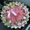 Pink rose bouquet with a white ribbon and small pink flowers