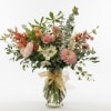 A loose, airy bouquet of mixed-color blooms greets the room with garden-fresh