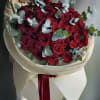 Bouquet of red roses with eucalyptus in cream wrapping