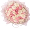 Pink and cream rose bouquet wrapped in pale pink paper with pearl accents