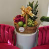 Fruit basket with roses and a gold bow