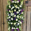 A tall, formal standing spray that reads with quiet dignity-this sympathy flower