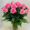 Pink roses arranged in a clear glass vase