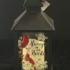 Black lantern with cardinals and flowers reading 