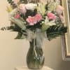 This bouquet has pink roses, lilies, and eucalyptus for that nice delicate