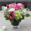 Pink and white mixed flower arrangement in a glass vase