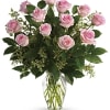 Arrangement of light pink roses in a clear glass vase