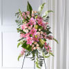 Tall pink and white standing spray with lilies and roses on a metal easel