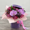 Arrangement of Deep Purple roses, and Orchids in a beautiful velvet flower