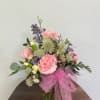 Soft pink carnations, delicate Astrantia, yellow mini carnations arranged in a clear
