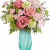 Pink roses and pale flowers in a turquoise vase