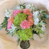 This arrangement has hydrangea, stock, roses, Alstroemeria, and greenery