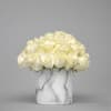 White rose bouquet in a marble-patterned vase