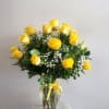 Yellow roses arranged in a clear glass vase with baby's breath