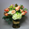Bouquet of red-edged roses and pale hydrangeas in a glass vase