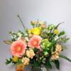 Mixed bouquet with pink gerbera daisies and yellow roses in a glass vase