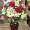 Lush red roses, white daisy and playful white alstromeria come together to