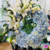 Blue hydrangea wreath with white lilies and cream roses