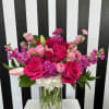 Pink and purple mixed bouquet in a clear glass vase