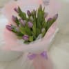 Bouquet of purple tulips wrapped in pink paper