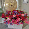 Red roses and pink lilies in a white box with a birthday balloon