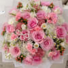 Pink rose bouquet with white accent flowers and paper wrap