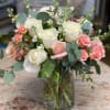 White and pink roses in a clear glass vase