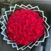 Large bouquet of red roses wrapped in geometric black and white paper