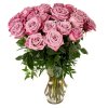 Tall arrangement of mauve pink roses in a clear glass vase