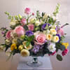 A lush, garden-fresh composition of mixed bouquets in soft pastels-this Spring Garden