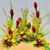 Tropical floral arrangement with red, yellow, and orange blooms