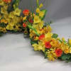 Yellow and red floral garland arranged in a curved shape