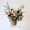This radiant arrangement embodies joy and compassion, blending rich hues and lush