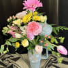 Pretty tumbler with a lovely assortment of fresh flowers, pink ranunculus, tulips