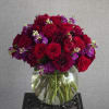 Compact, with beautiful roses, daliahs(seasonal) and red peonies. Note: Some of these