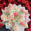 Bouquet of pink and white flowers wrapped in translucent paper