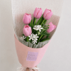 Pink tulip bouquet with small white flowers wrapped in pink paper