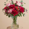 A lacquered artwork in deep shades of red, this arrangement heroes large