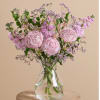 Pink petal pops on a lush green canvas, this arrangement features billowing