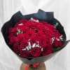 Bouquet of red roses with white baby's breath in black wrap