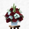 Red roses and white flowers in a light blue box