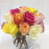 Bouquet of multicolored roses in a clear glass vase