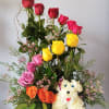 Mixed rose arrangement with a white dog-shaped floral figure