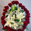 Red roses and white lilies arranged in a white vase