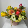 Mixed bouquet in a pink vase with yellow, white, and pink blooms